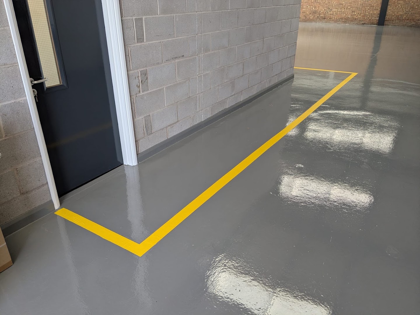 Yellow walkway road marking on a warehouse floor
